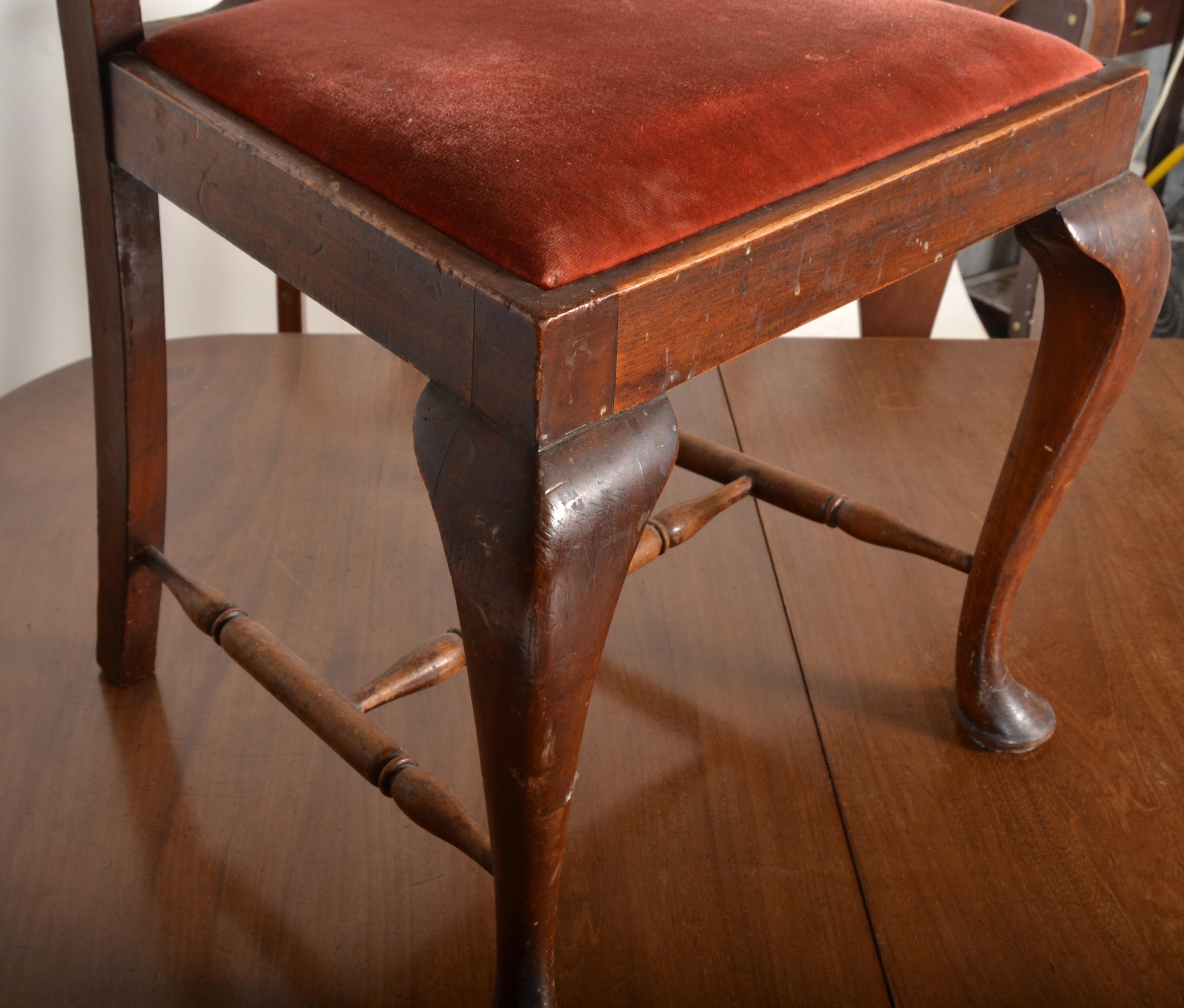 A 1920s mahogany extending dining table with cabriole legs along with 6