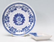 An 18th Century Chinese blue and white dish decorated with a greek key border and central Buddhist