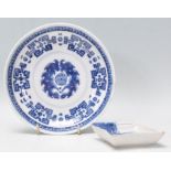 An 18th Century Chinese blue and white dish decorated with a greek key border and central Buddhist