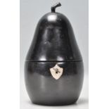 An antique style tea caddy in the form of a pear carved from ebonised wood having a shield scutcheon