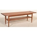 A good mid century Danish influence teak wood long john coffee table of rectangular form with