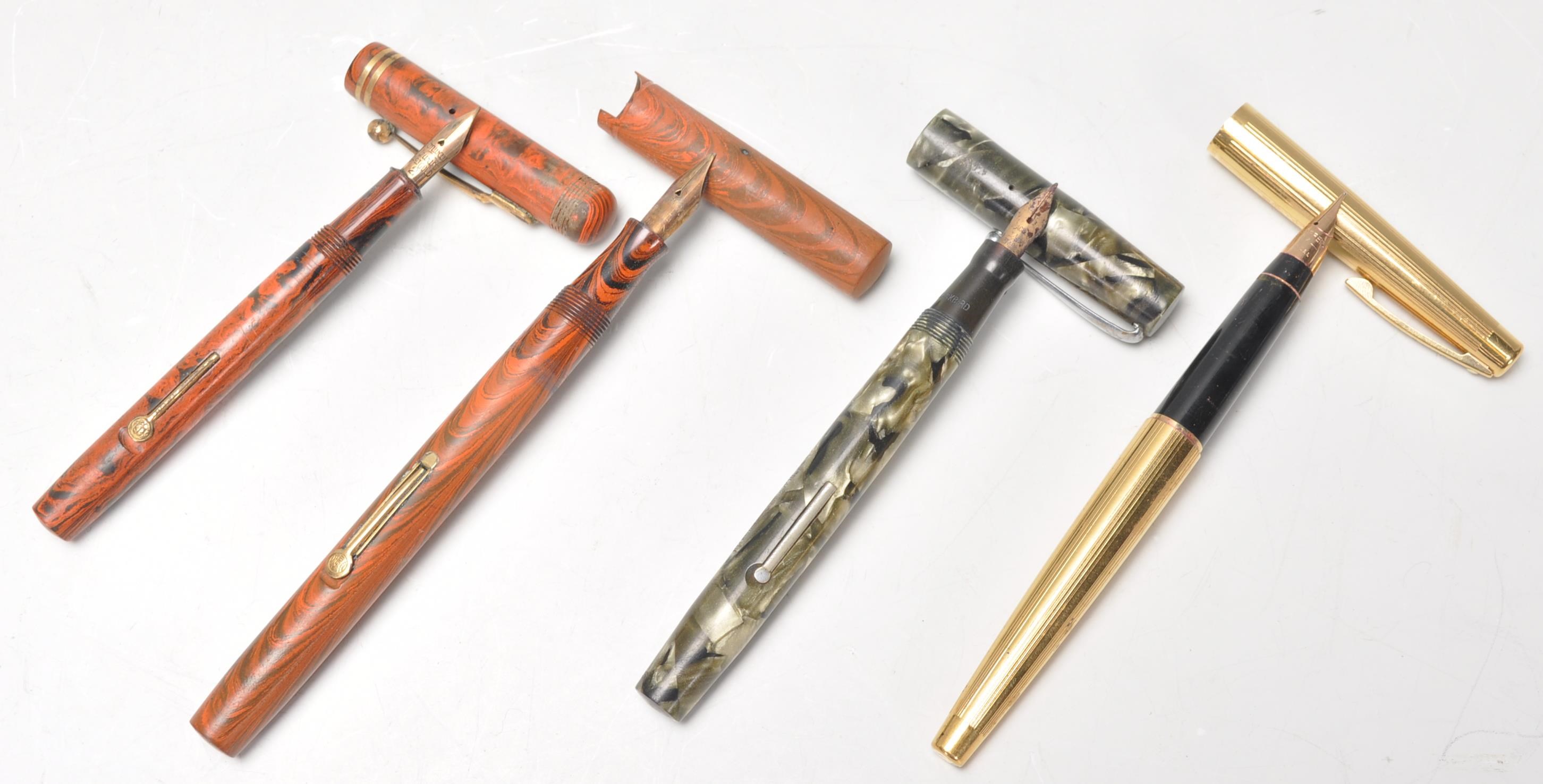A good mixed group of four vintage 20th Century fountain pens with each pen having a 14ct gold