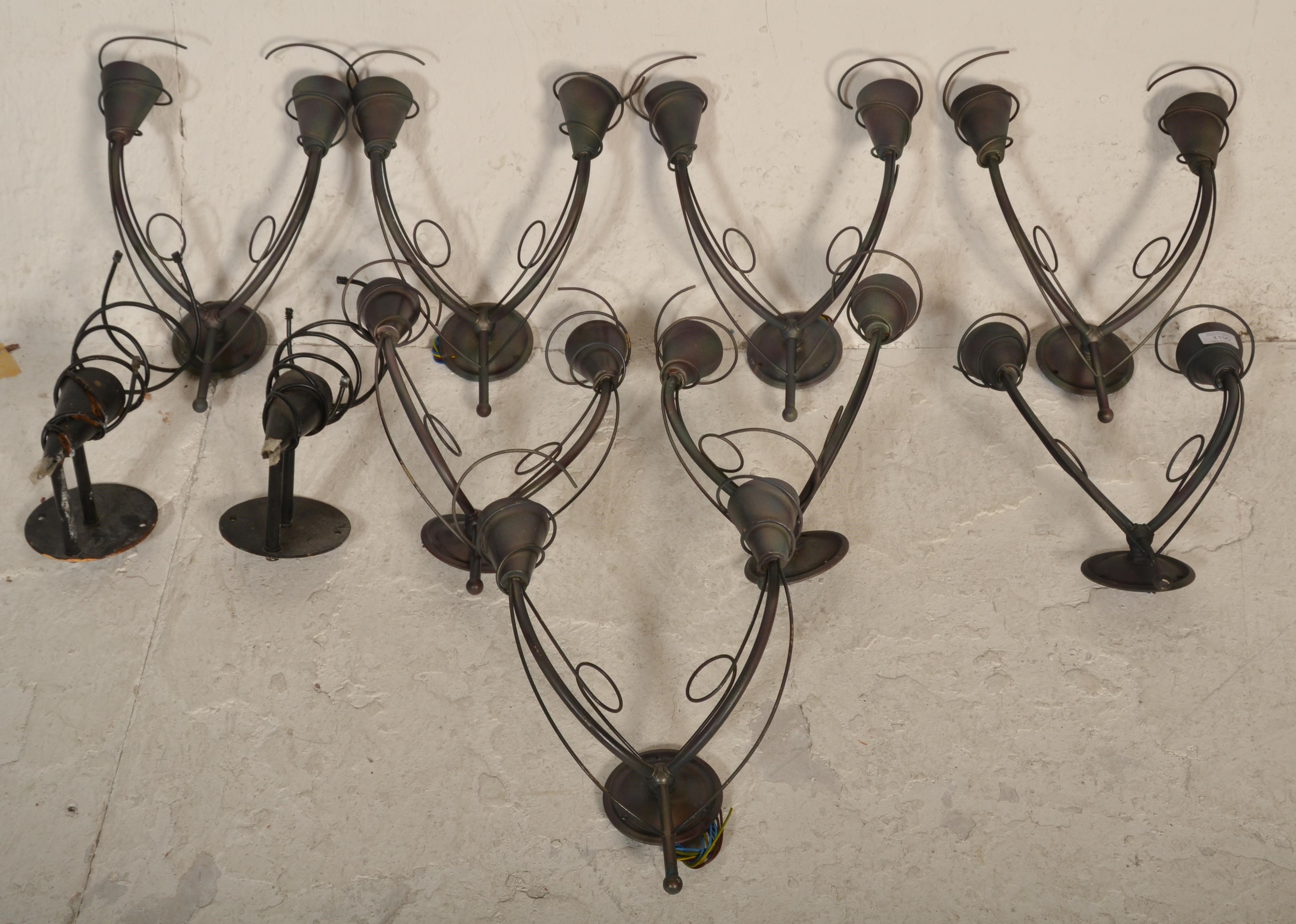 A collection of 8 modern 20th century twin sconce wall lights. Each of brushed metal form having