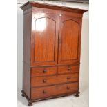 A Victorian 19th century mahogany Linen press with a moulded cornice over two panelled doors