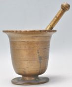 A 18th Century bronze pestle and mortar of tapering cylindrical form having a flared rim atop raised