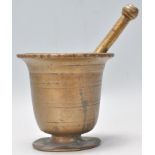 A 18th Century bronze pestle and mortar of tapering cylindrical form having a flared rim atop raised