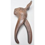 A good early 20th century black forest carved wooden pair of nut crackers in the form of a