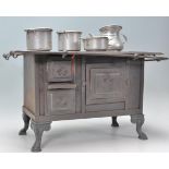 A vantage 20th Century miniature cast iron model of a Victorian stove / oven having a series of