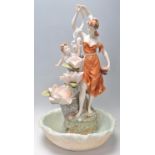 A vintage Italian resin Capodimonte style water feature in the form of a female figure amongst