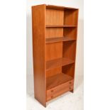 A retro 20th century Danish influence teak wood upright bookcase cabinet. The library bookcase