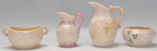 A group of four Belleek small vessels, all being lustre glazed to include a shamrock basket design