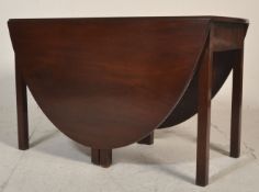 A 19th century Victorian mahogany drop leaf gate leg dining table being raised on squared legs