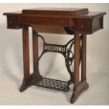 A Victorian 19th century cast iron and oak Singer Sewing Machine table. The cast iron painted tredle