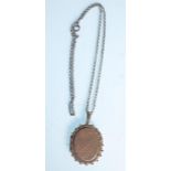 A silver Victorian 19th century locket of oval form with finial borders, chase decorated body and