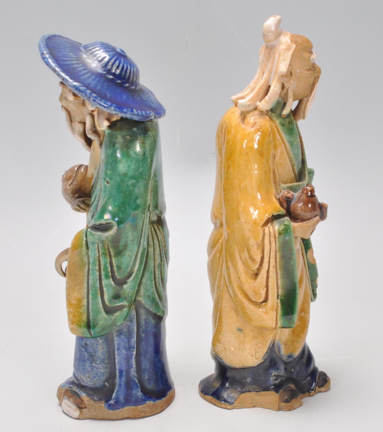 A pair of 1920's Chinese export Ming Dynasty style ceramic figurines in the form of two men glazed - Image 4 of 7