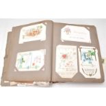 A vintage 20th Century postcard album containing a wide selection of postcards dating from the