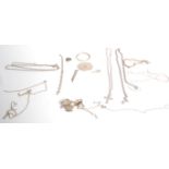 A collection of silver jewellery to include a figaro chain necklace, a crucifix pendant, a heart