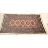 A vintage 20th Century Persian Islamic floor rug / carpet having multi coloured ground with
