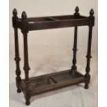 A Victorian 19th century carved oak stick / umbrella stand having twin sections with turned column