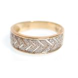 A hallmarked 14ct gold ring having pierced decoration plait design set with diamonds. Hallmarked