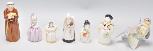 A group of six Royal Worcester porcelain candle snuffers to include a monk, a nun, a Chinese figure,