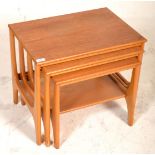 A retro 20th Century teak nest of graduating tables raised on quadrille style supports. Measures
