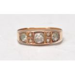 A Victorian hallmarked 15ct gold ladies ring set with a central round cut white stone flanked by