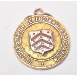 Local Interest - A hallmarked 9ct gold medal / fob for the Gloucestershire Football Association.