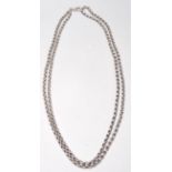 A vintage 20th Century silver long guard chain having rounded links. Weighs 89.4g. Measures 30