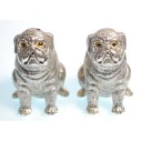 A pair of stamped 800 silver salt and pepper condiments in the form of pug dogs having yellow and
