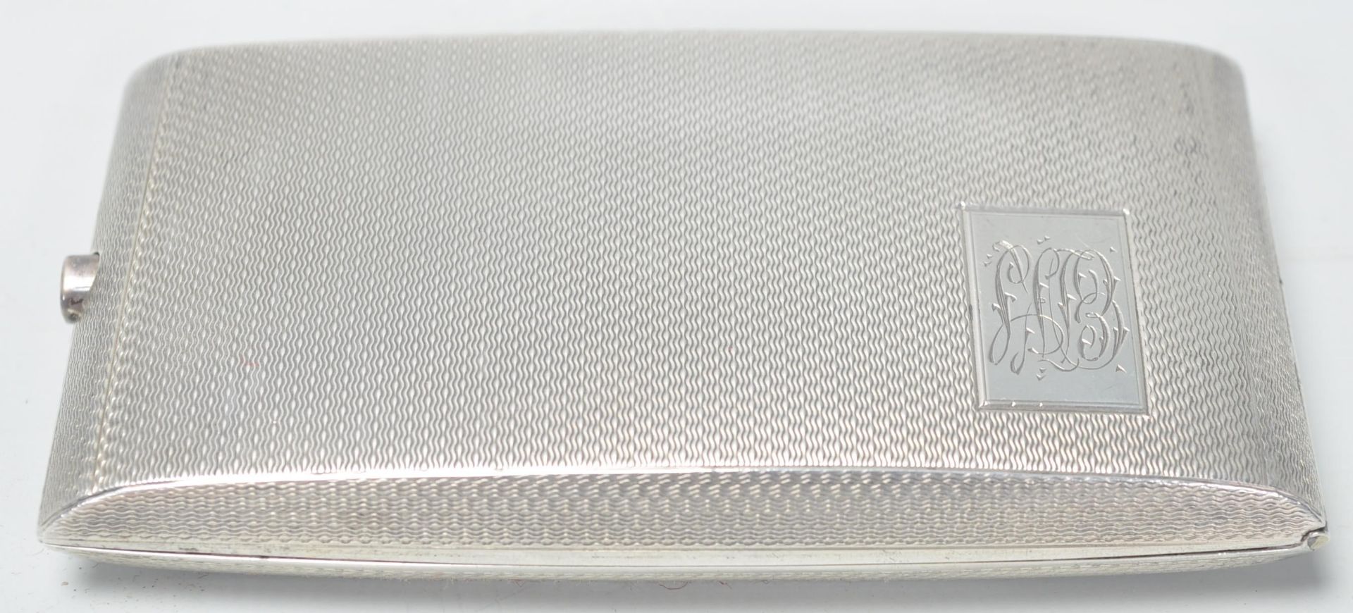 A silver hallmarked cigarette case of rectangular shape having engine turned decoration with - Image 2 of 6