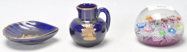 A porcelain miniature jug having a royal blue glaze with a gilt crest of the Order of the