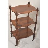 A 19th Century Victorian mahogany three tier whatnot etagere having serpentine shelves with turned