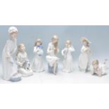 A group of seven Nao figurines to include an angel playing an instrument, a lady washing her feet, a
