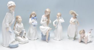 A group of seven Nao figurines to include an angel playing an instrument, a lady washing her feet, a