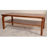 A vintage retro teak wood coffee table of rectangular form having two tiers united by square bent