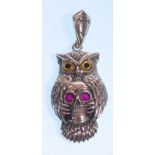 A stamped 925 silver necklace having a rope twist chain with an owl pendant having yellow and
