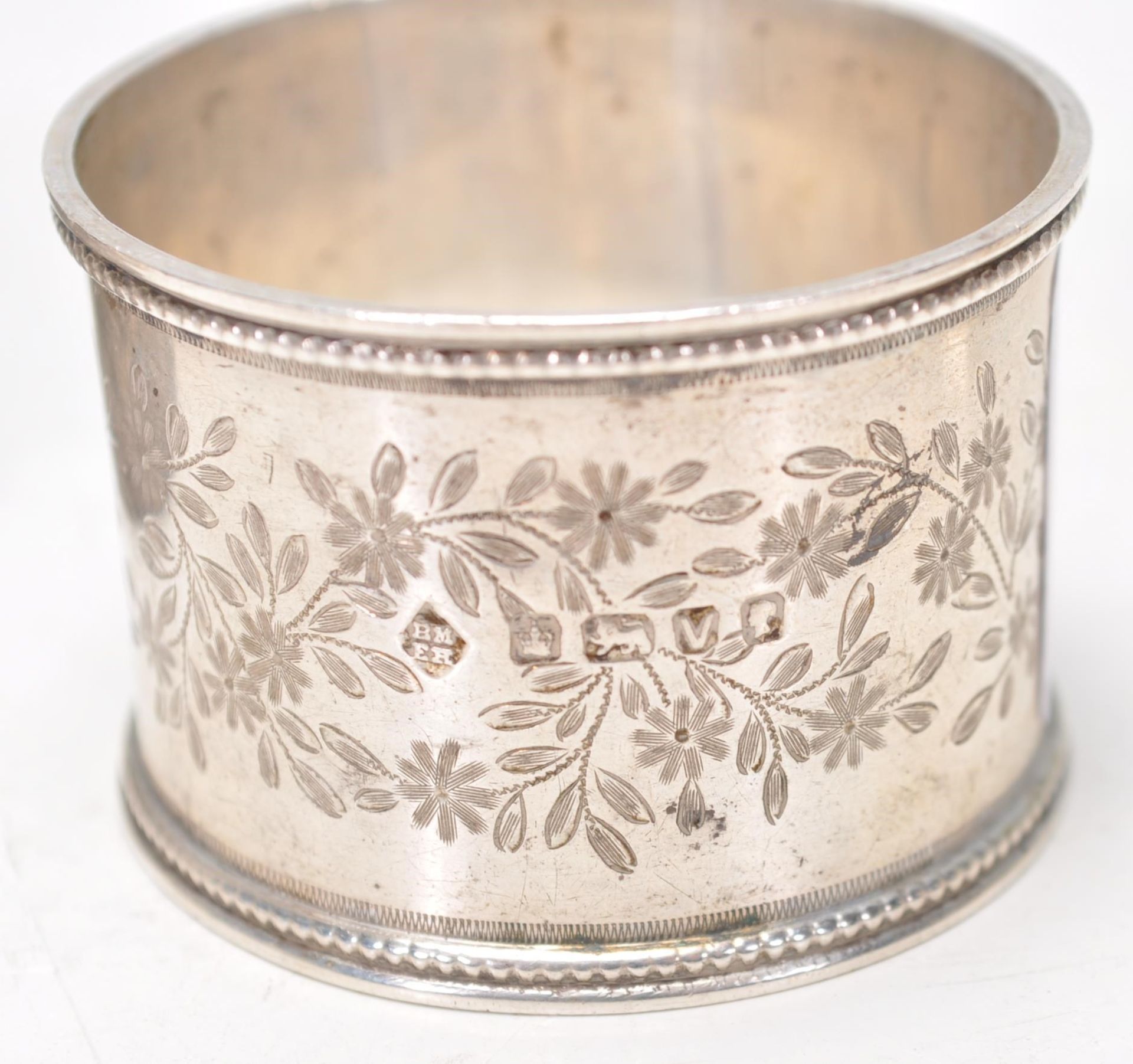 A group of four silver hallmarked napkin rings to include a napkin ring with gadrooned border ( - Image 5 of 6