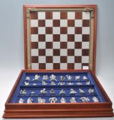 A Danbury Mint 'The Fantasy of the Crystal' chess set consisting of mythical pewter chess pieces
