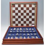 A Danbury Mint 'The Fantasy of the Crystal' chess set consisting of mythical pewter chess pieces