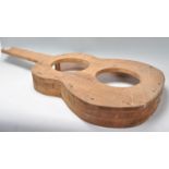 A vintage 20th Century wooden guitar mould maker of typical acoustic guitar form.  Measures 85 cm