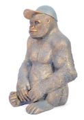 20TH CENTURY FIBREGLASS STATE OF A GORILLA WITH CAP