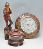 An early 20th Century carved oak barometer of circ