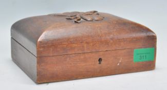 An early 20th Century carved oak trinket box of re