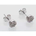 A pair of 18ct white gold stud earrings inset with