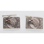 A pair of sterling silver cufflinks embossed with