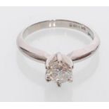 An 18ct white gold solitaire ring inset with a bri