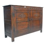 An early 20th Century Jacobean revival Ipswitch sideboard cupboard having twin doors with carved
