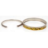 Two silver bangle bracelets to include a leopard printed decorated example hallmarked for London.