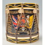 A 20th Century military related ice bucket in the form of a drum having a black cylindrical body